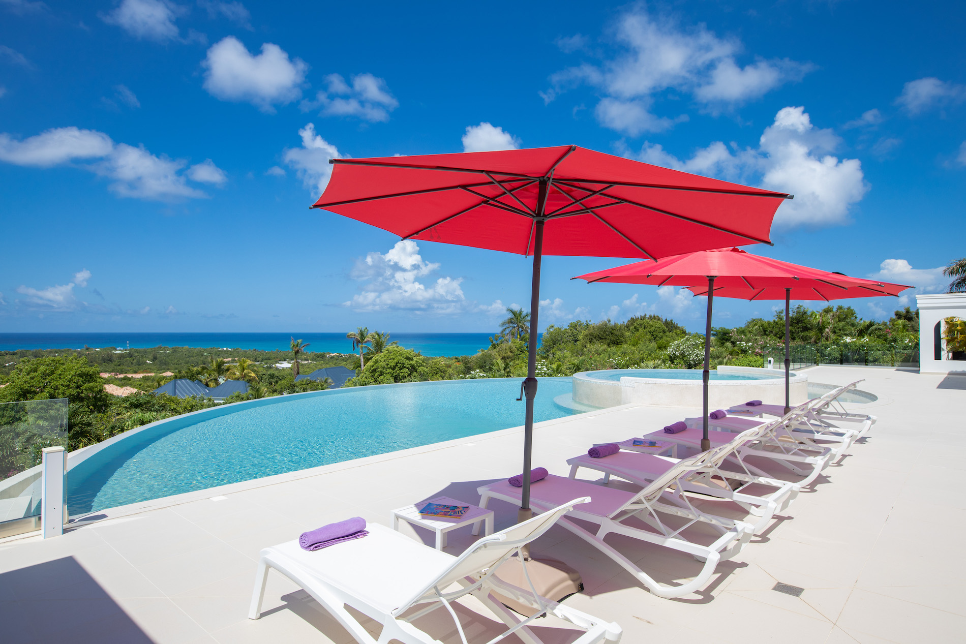 Infinity pool, sea views and red parasols at Just in Paradise