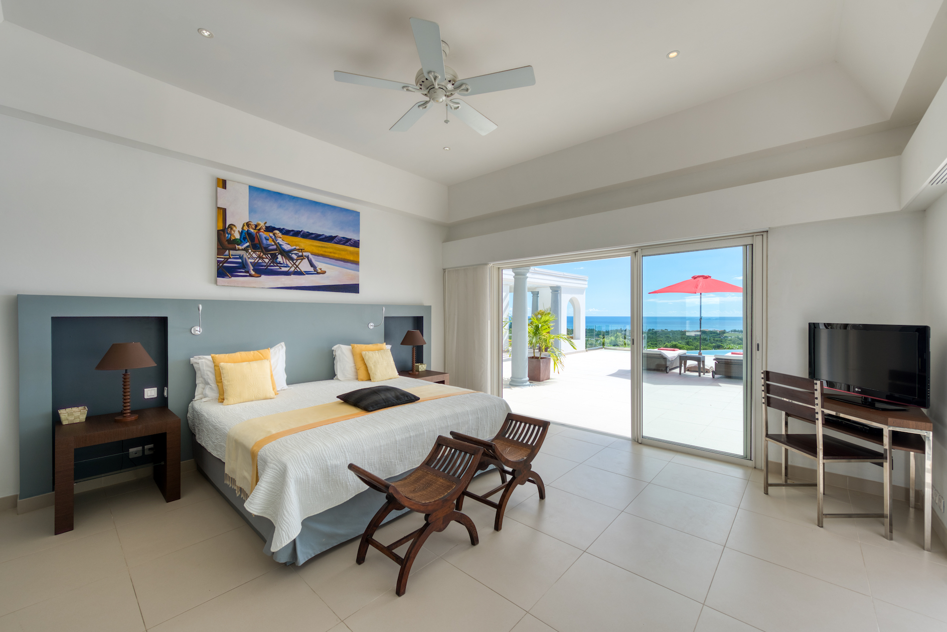 Yellow-accent bedroom opening onto the pool terrace