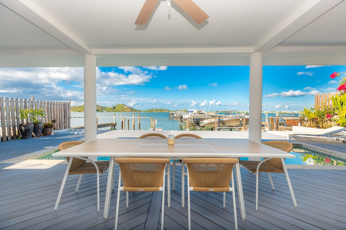 Outdoor dining table on the terrace overlooking the lagoon